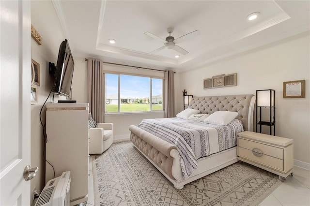 tiled bedroom with ceiling fan, a raised ceiling, and ornamental molding