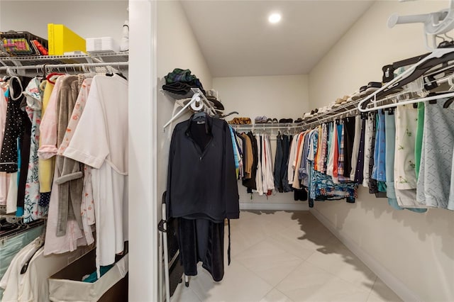 spacious closet with light tile patterned floors