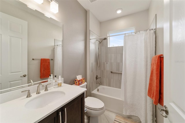 full bathroom with tile patterned floors, shower / tub combo with curtain, vanity, and toilet