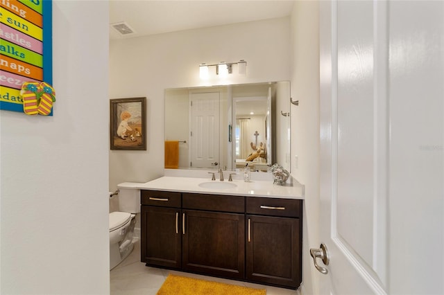 bathroom with tile patterned floors, vanity, and toilet