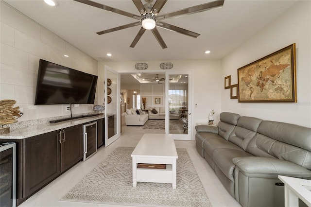 tiled living room featuring wine cooler and ceiling fan