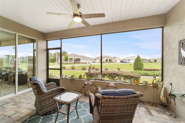 sunroom featuring ceiling fan