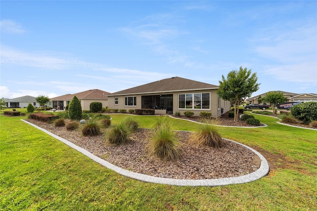 back of property featuring a lawn