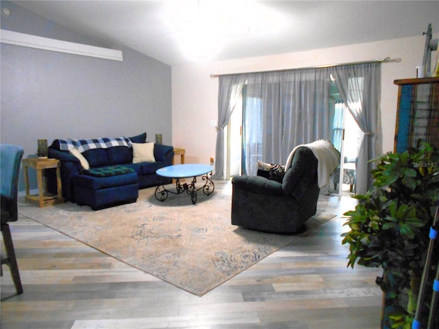 living area featuring lofted ceiling and wood finished floors