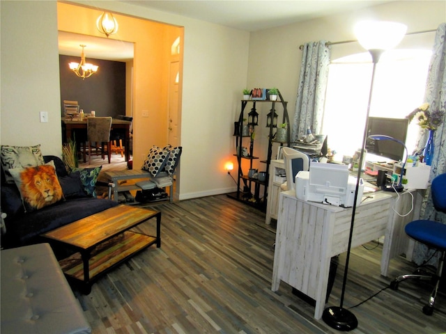 living room featuring an inviting chandelier, baseboards, and wood finished floors