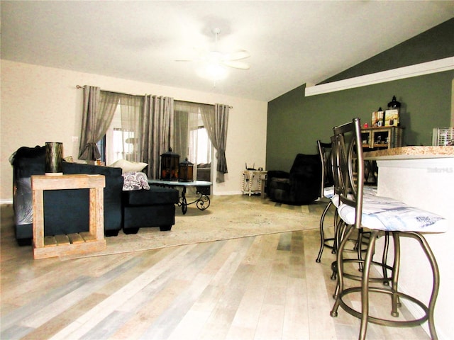 living room with vaulted ceiling and wood finished floors