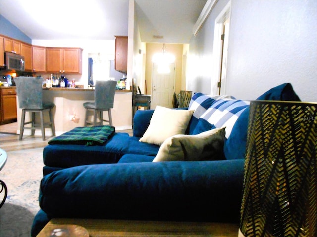 living room with lofted ceiling and light wood finished floors