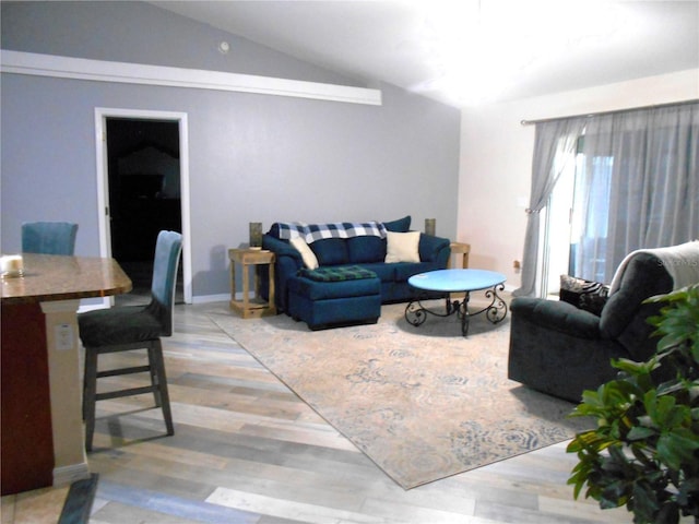 living area with light wood-style floors and lofted ceiling