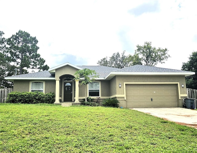 ranch-style home with driveway, a garage, stucco siding, fence, and a front yard