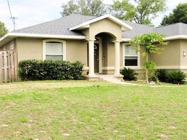 single story home featuring roof with shingles, fence, and stucco siding