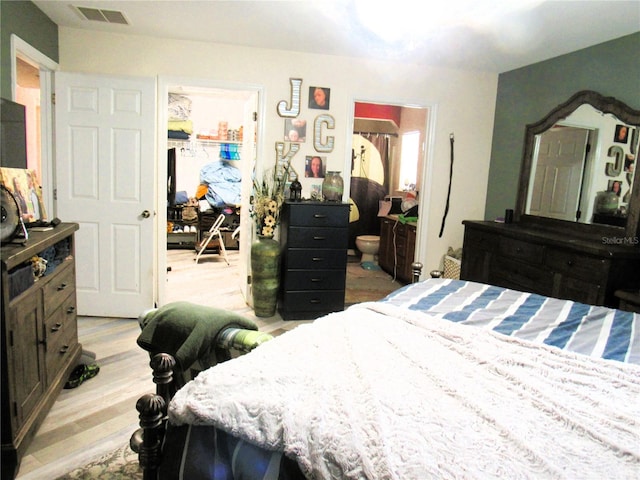 bedroom featuring light wood-style floors and visible vents