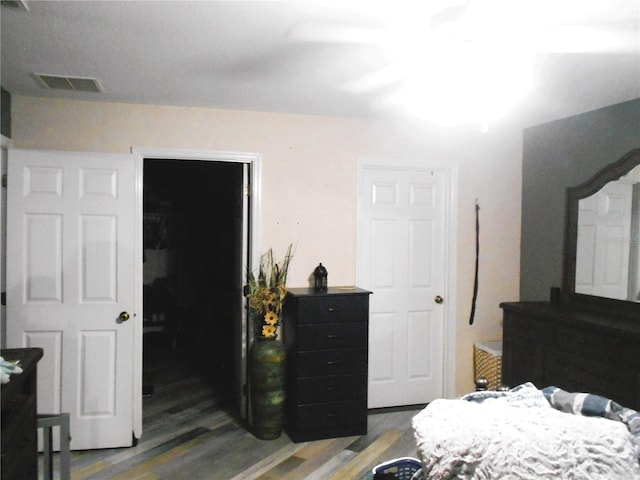 bedroom with visible vents and wood finished floors