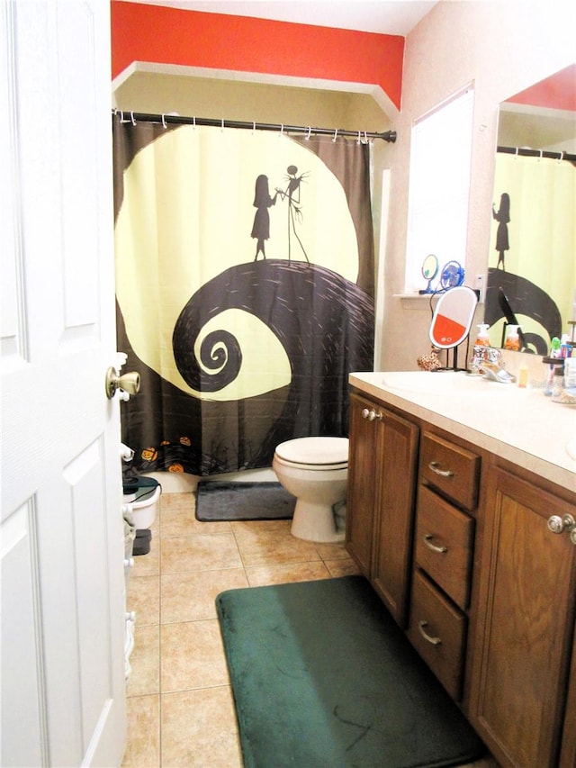 bathroom with vanity, toilet, and tile patterned floors