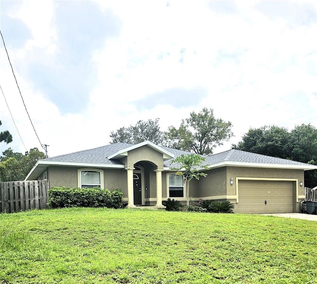 single story home featuring a front yard and a garage