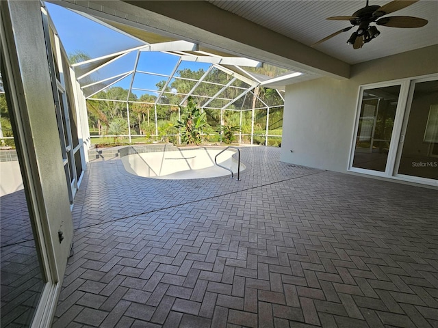 unfurnished sunroom featuring ceiling fan