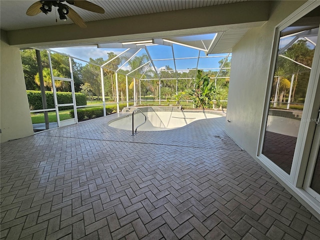 unfurnished sunroom with ceiling fan