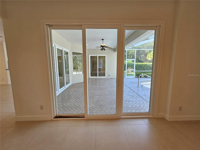 doorway to outside featuring ceiling fan and light tile flooring