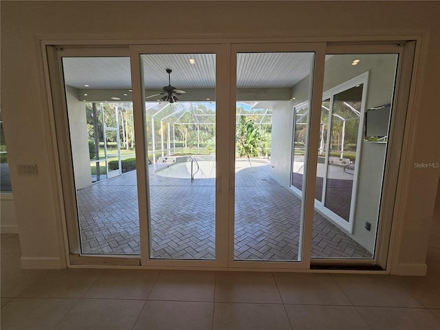 doorway to outside featuring tile floors and ceiling fan