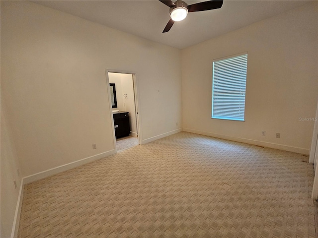 carpeted spare room with ceiling fan