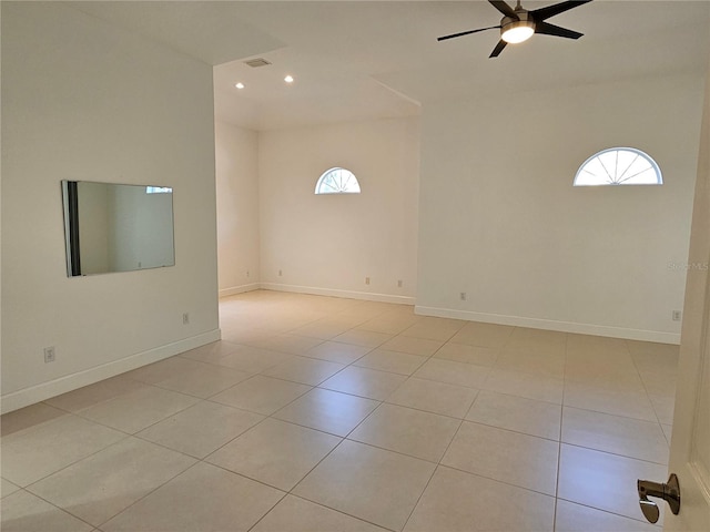 spare room featuring ceiling fan and light tile floors