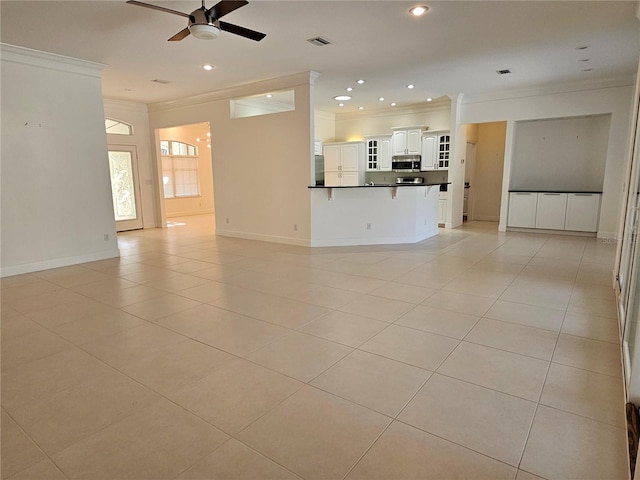 unfurnished living room featuring ceiling fan, light tile flooring, and crown molding