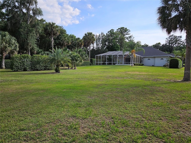 view of yard featuring glass enclosure