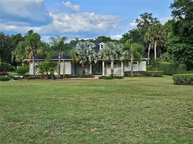 ranch-style home featuring a front lawn