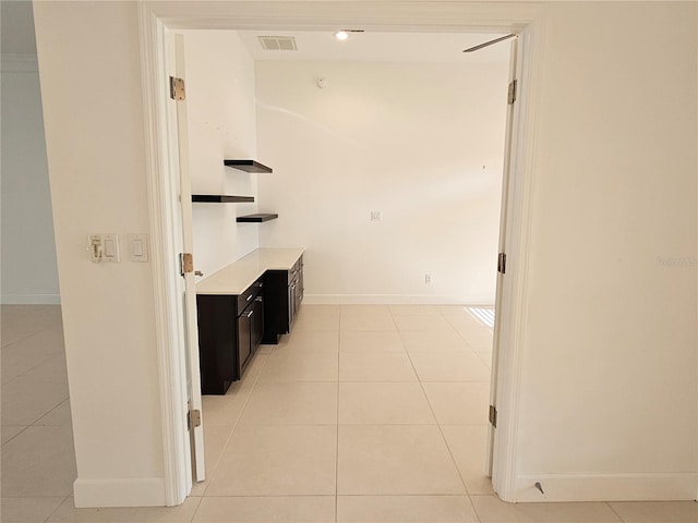 corridor featuring light tile floors