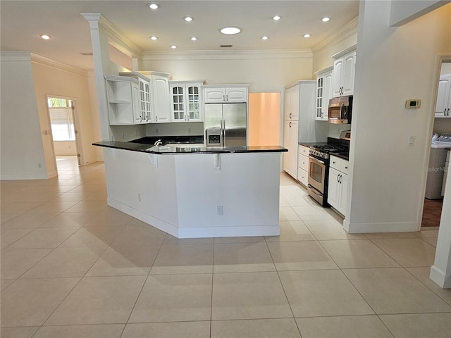 kitchen featuring stainless steel appliances, kitchen peninsula, light tile flooring, and white cabinetry