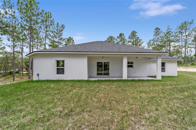 back of house with ceiling fan, a yard, a patio area, and stucco siding