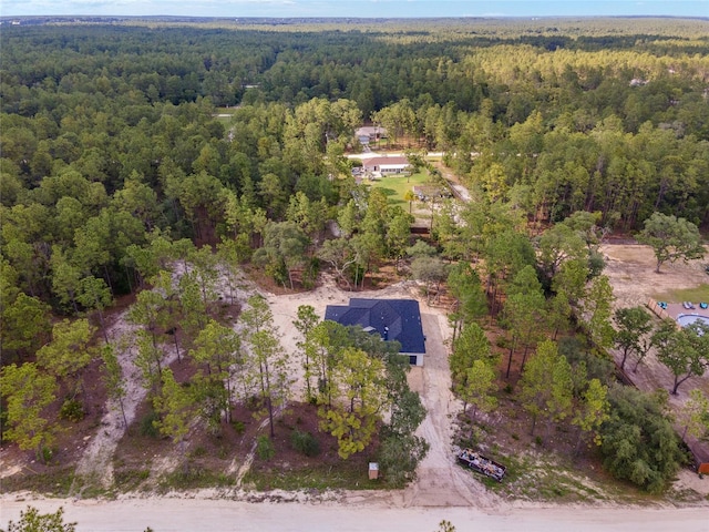 drone / aerial view with a wooded view