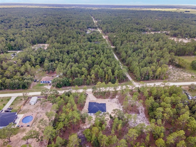 birds eye view of property with a wooded view