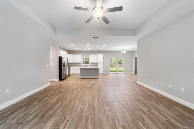 unfurnished living room featuring light wood finished floors, baseboards, a ceiling fan, and recessed lighting