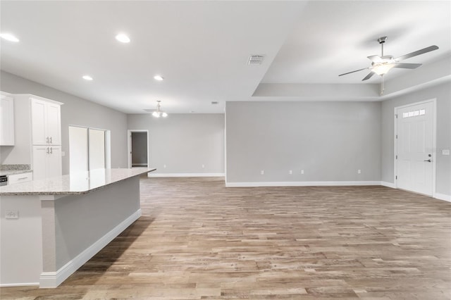 unfurnished living room featuring recessed lighting, a ceiling fan, baseboards, visible vents, and light wood-style floors