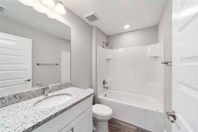 full bath with visible vents, vanity, toilet, and wood finished floors