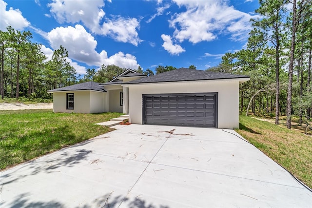 view of front of house with a garage and a front lawn