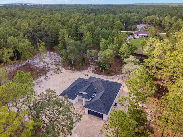 drone / aerial view featuring a forest view