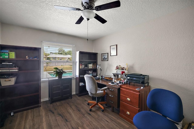 office area with ceiling fan, dark wood-type flooring, and a textured ceiling