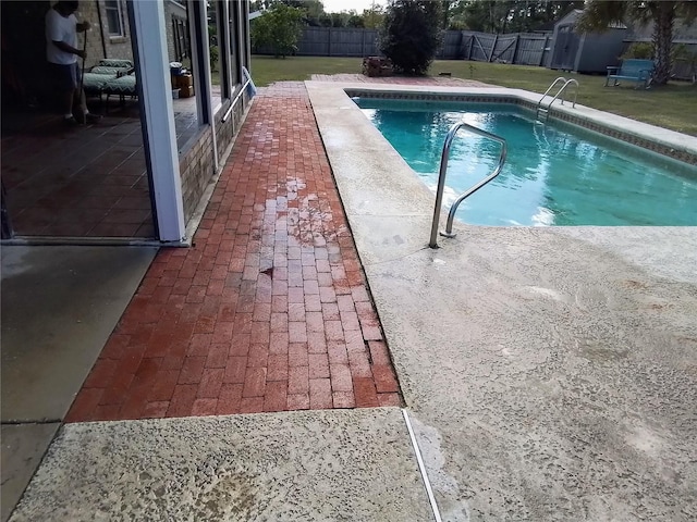 view of pool with a yard and a patio area