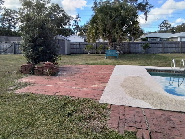 view of yard featuring a fenced in pool, a patio, and a storage shed