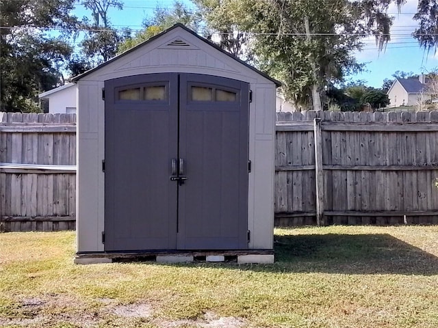 view of outdoor structure featuring a lawn