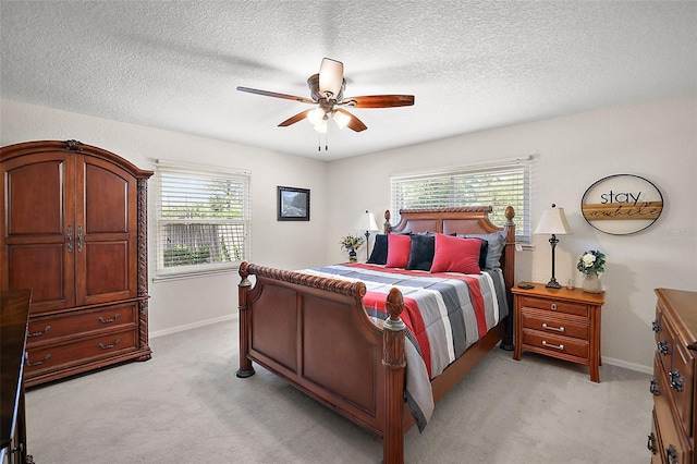 bedroom featuring ceiling fan and light carpet