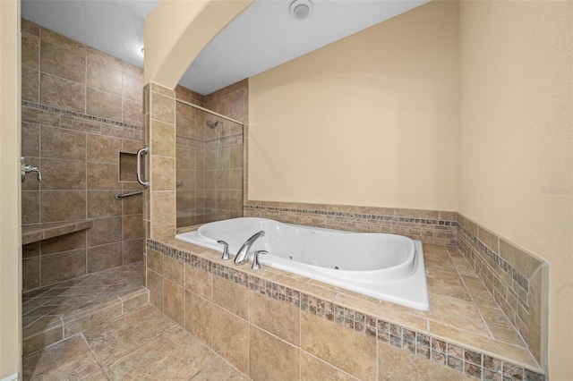 bathroom featuring tile floors and independent shower and bath