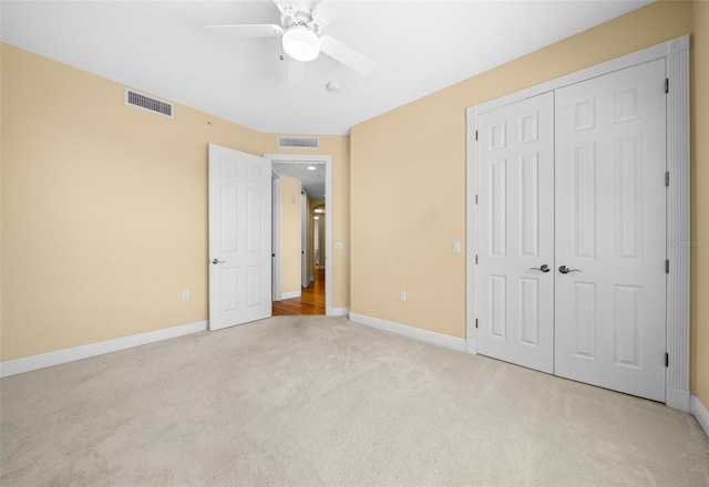 unfurnished bedroom with a closet, ceiling fan, and carpet floors