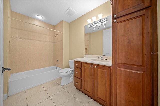 full bathroom with tiled shower / bath, tile flooring, toilet, and vanity