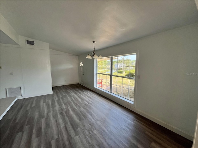 unfurnished dining area with lofted ceiling, dark hardwood / wood-style floors, and an inviting chandelier