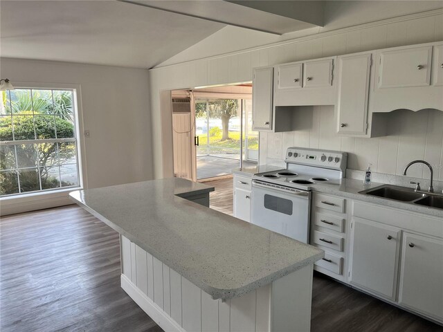 kitchen with dark hardwood / wood-style flooring, white range with electric stovetop, sink, white cabinetry, and lofted ceiling