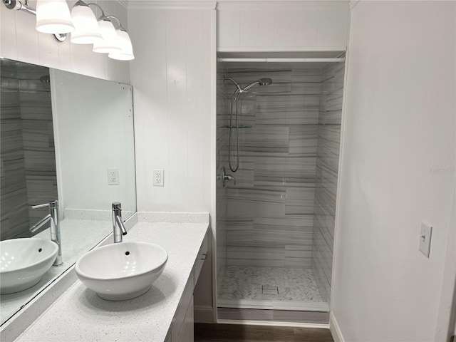 bathroom with vanity and tiled shower