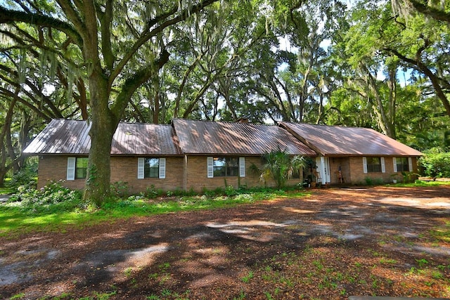 18001 SE Hawthorne Rd, Hawthorne, FL 32640 - single story home featuring dirt driveway, metal roof, and brick siding