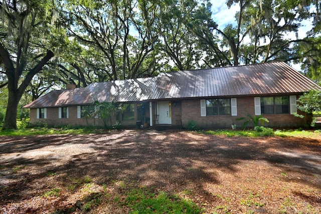 18001 SE Hawthorne Rd, Hawthorne, FL 32640 - single story home with brick siding and metal roof